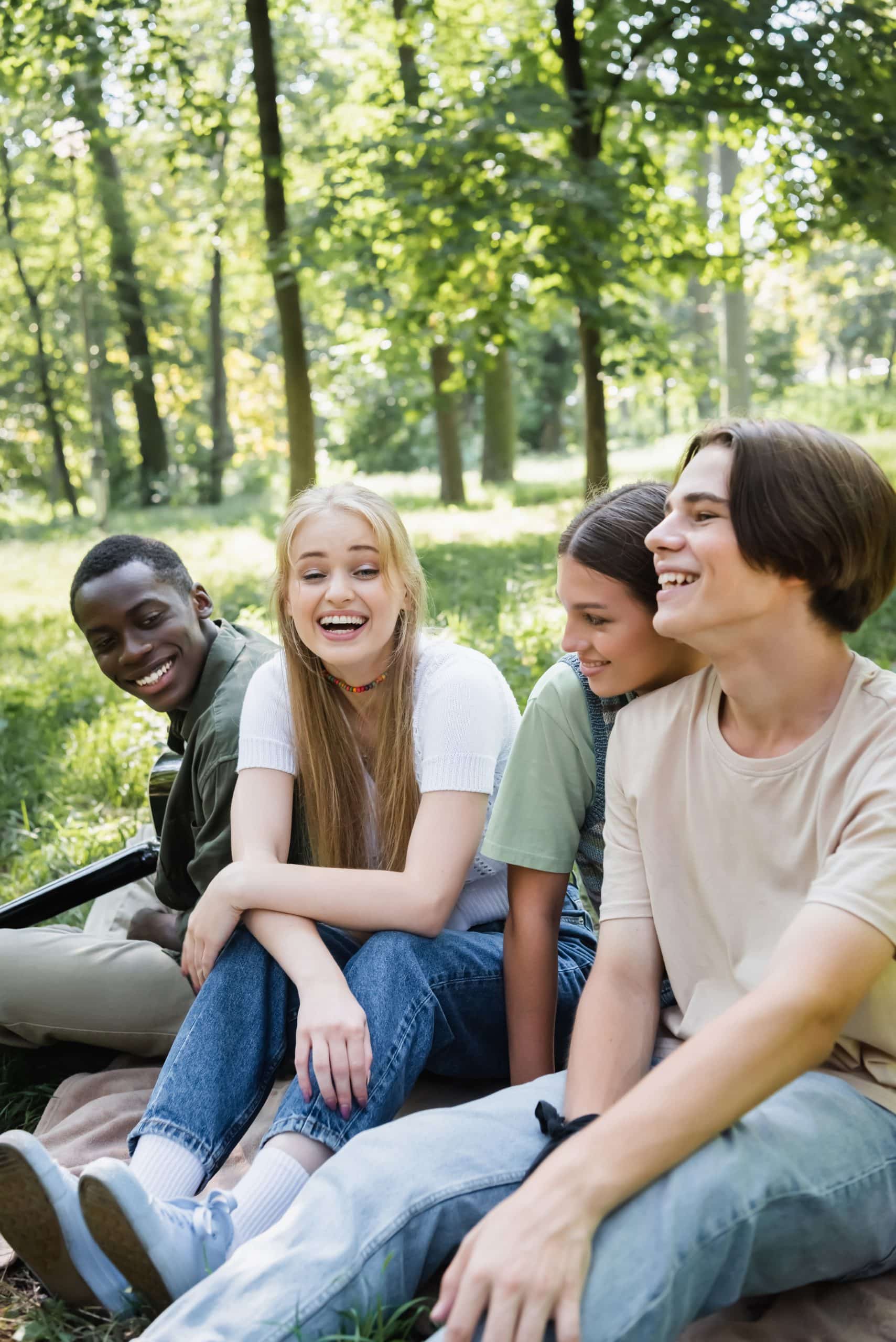 Cheerful teen friends sitting after orthodontic treatment