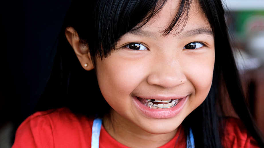 young girl smiling with early orthodontic care in alpharetta ga